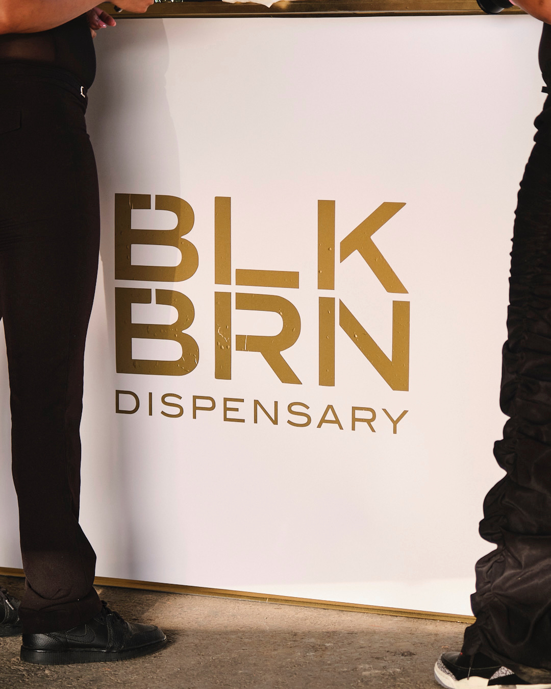 BLKBRN Dispensary storefront wall with gold logo